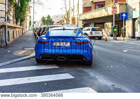 Back View Of Blue Jaguar F Type P300 Parked Near Pedestrian Crossing In Bucharest, Romania, 2020