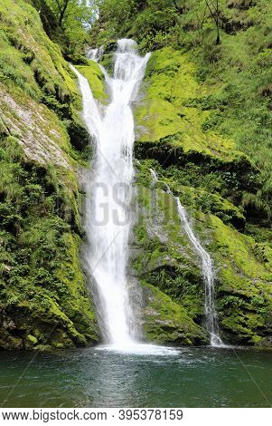 Small Waterfall In The Middle Of The Lush Forest With The Clean And Fresh Water Hole