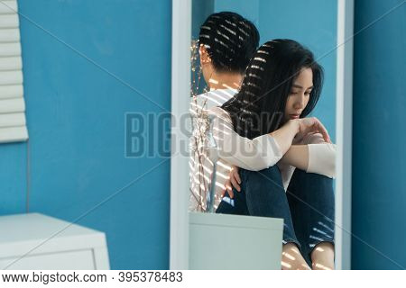 Unhappy Woman In The Mirror Sitting Behind Each Other On The Bed And Avoid Talking Or Looking At Eac