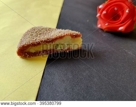 Triangle Shaped Diwali Sweet Isolated On Yellow Background