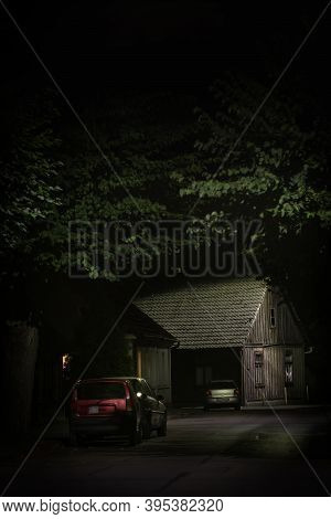 Old Wooden House Illuminated At The End Of Dark Silent And Empty Street