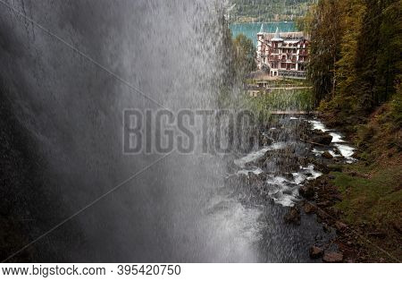 View On The Historic Giessbach Hotel Through Giessbach Waterfall In Bernese Oberland, Switzerland.