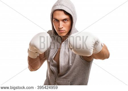 Young Handsome Muay Thai Boxer Looking Confidently To The Camera While Shadow Boxing. Professional M