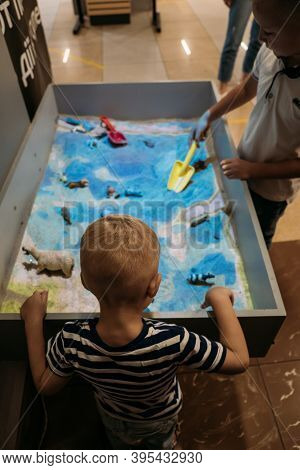 Kids Play With Augmented Reality Sandbox. Interactive Sandbox, Educational And Entertaining World Fo