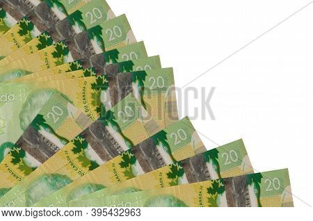 20 Canadian Dollars Bills Lies Isolated On White Background With Copy Space Stacked In Fan Close Up