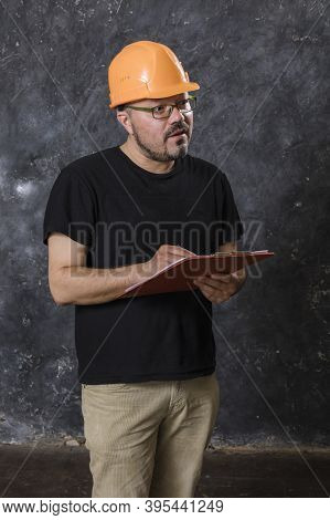 Middle-aged Man In A Helmet Construction Superintendent
