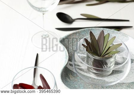 Elegant Table Setting With Floral Decor On White Wooden Background