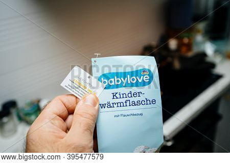 Paris, France - Nov 11, 2020: Pov Male Hand Holding Against Room Background New Sticker Of A Babylov
