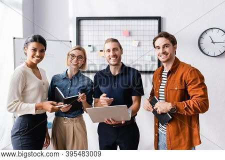 Ha Py Businessman Pointing At Laptop Near Happy Multicultural Colleagues