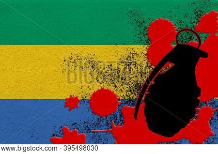 Gabon Flag And Mk2 Frag Grenade In Red Blood. Concept For Terror Attack Or Military Operations With 