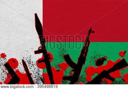 Madagascar Flag And Various Weapons In Red Blood. Concept For Terror Attack Or Military Operations W