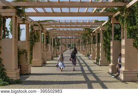 Pavlodar, Kazakhstan - July 27, 2020: Garden In Pavolodar With Strawling People On A Summers Day.
