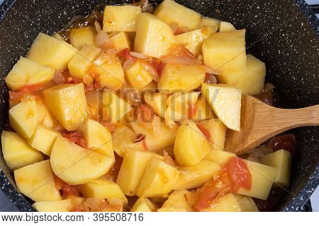 Cooking A Traditional Italian Vegetable Stew With Potatoes, Eggplants And Peppers In A Frying Pan - 