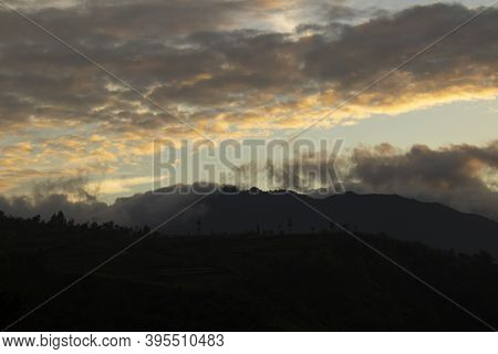 Cloudy Sky Over Mount Sindoro. Black Clouds With Morning Sunlight