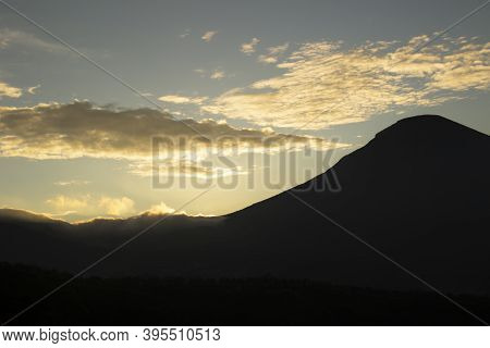 Cloudy Sky Over Mount Sindoro. Black Clouds With Morning Sunlight