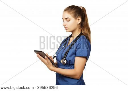 Healthcare, Technology And Medicine Concept - Female Doctor In Blue Surgical Suit With Stethoscope A