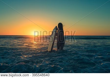 Woman With Bodyboard Enetering The Water To Catch Some Waves At Moana Beach During Sunset In South A