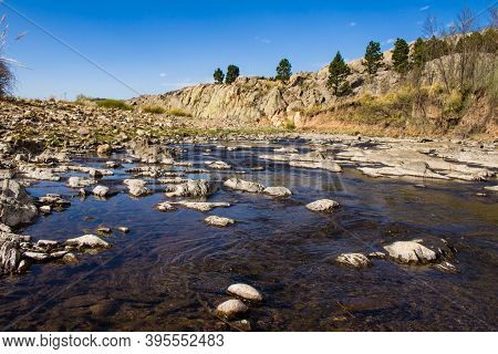 Beautiful Rocks At The Bottom Of The River With Little Water. Mountain Landscape. Mountain River