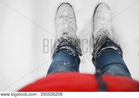 Feet In Winter Boots. Valenki Are Covered With Snow.