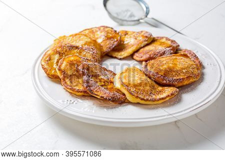 Homemade low calarie curd cheese pancakes on white plate.