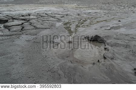 Mud Liquid Flowing From Mud Volcano, At Paclele Mari Mud Volcanoes In Buzau, Romania. Small Volcano-