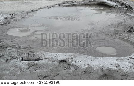 Bubbling Crater Of A Mud Volcano. Close Up View Onto Gas Bubble Exploding In Crater Of Mud Volcano. 