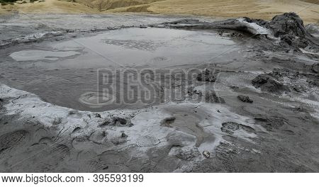 Bubbling Crater Of A Mud Volcano. Close Up View Onto Gas Bubble Exploding In Crater Of Mud Volcano. 