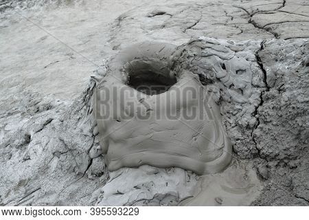 Mud Liquid Flowing From Mud Volcano, At Paclele Mari Mud Volcanoes In Buzau, Romania. Small Volcano-