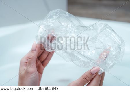 A Close-up Of A Shower Cap. Girl Holding A New Shower Cap