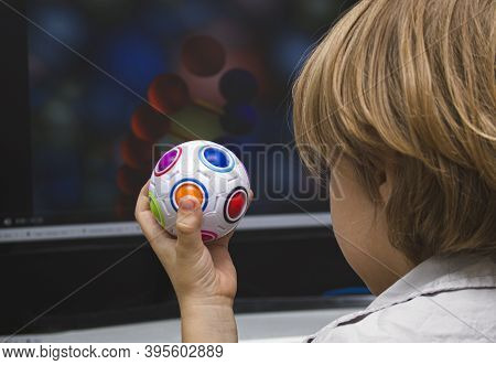 The Child With Enthusiasm Looks At The Monitor Screen. An Educational Program Or Useful Cartoons For