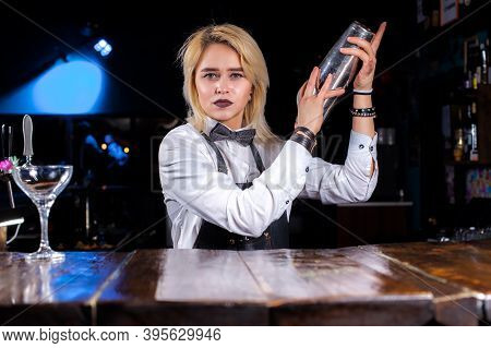 Experienced Woman Barman Demonstrates His Professional Skills While Standing Near The Bar Counter In