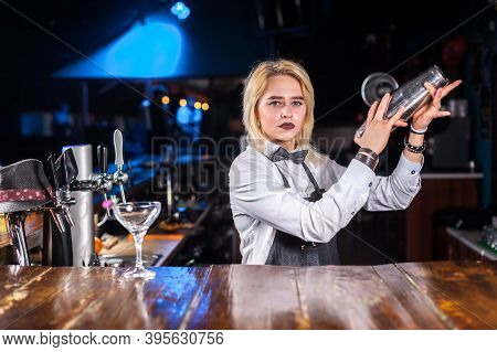 Confident Girl Barkeeper Pouring Fresh Alcoholic Drink Into The Glasses At The Bar Counter
