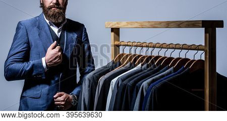 Man Suit, Tailor In His Workshop. Male Suits Hanging In A Row. Men Clothing, Boutiques. Tailor, Tail