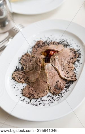 Sliced Ham Served With Vegetables On A Ple