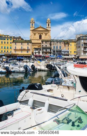 View On église Saint Jean-baptiste In Bastia From The Vieux Port With Some Boats Resting In The Habo