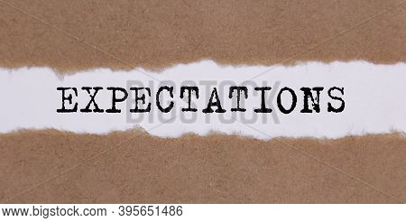 Expectations Word Written Behind Torn Paper. Business