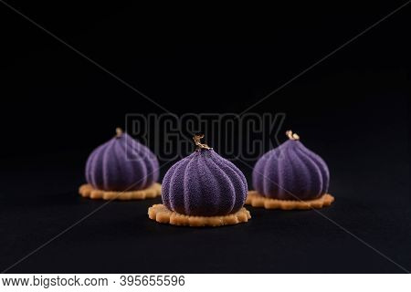 Three Small Square Cakes Decorated With Gold On Top On Cookies In Cafeteria. Closeup View Of Matte P