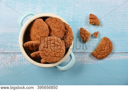 Close Up Round Artisan Oatmeal Cookies In Pannikin Bowl On Blue Painted Rustic Wooden Table, Elevate