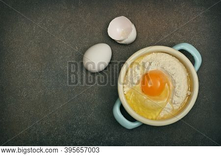 Close Up Flat Lay Of Baking Ingredients On Dark Grunge Stone Table Surface With Copy Space, Flour An