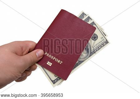 Passport And Money In The Hands Of A Man On A White Background. Man Gives A Bribe By Putting Money I