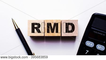 Rmd Is Written On Wooden Cubes Between A Pen And A Calculator On A Light Background.