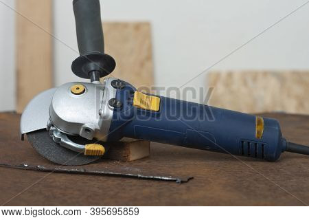 Angle Grinder With Thinner Cut-off Disc On  Old Rusty Metal Sheet.