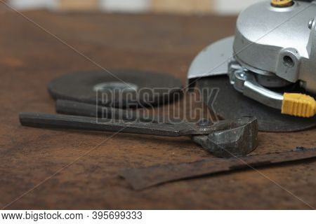 Black Splitting Pliers And  Angle Grinder With Thinner Cut-off Disc And  Grinding Disc On  Old Rusty