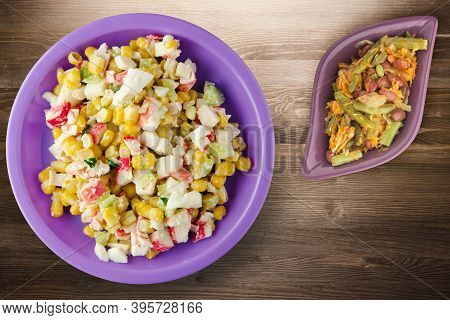 Crab Salad On Purple Plate With Vegetaible Salad Top View. Crabs Salad On Brown Wooden Background