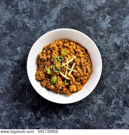 Close Up View Keema Curry In Bowl Over Blue Stone Background. Indian And Pakistani Style Dish. Top V