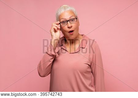 Surprised Senior Woman Looking Through Glasses Otices Something Unexpected,