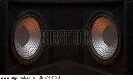 Black subwoofer speaker car audio music system on orange background