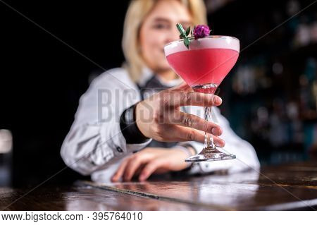 Young Woman Bartending Intensely Finishes His Creation While Standing Near The Bar Counter In Nightc