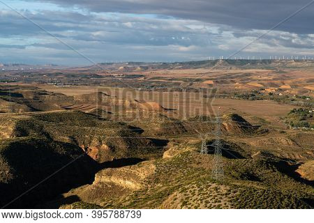 Views Of The Semi-desert Valley Of Huerva With The Windmills Of La Muela And Several Poles And Elect