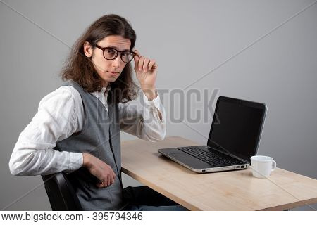 Programming And Application Development, A Young Man Writes Code Sitting At A Laptop. Training In Pr